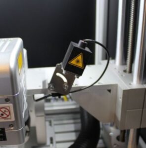 Dodatkowy pomocniczy laser pozycjonujący wysokość głowicy znakującej